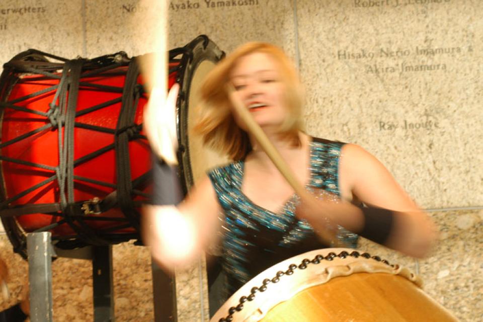 Heidi Varian blurred in motion while drumming